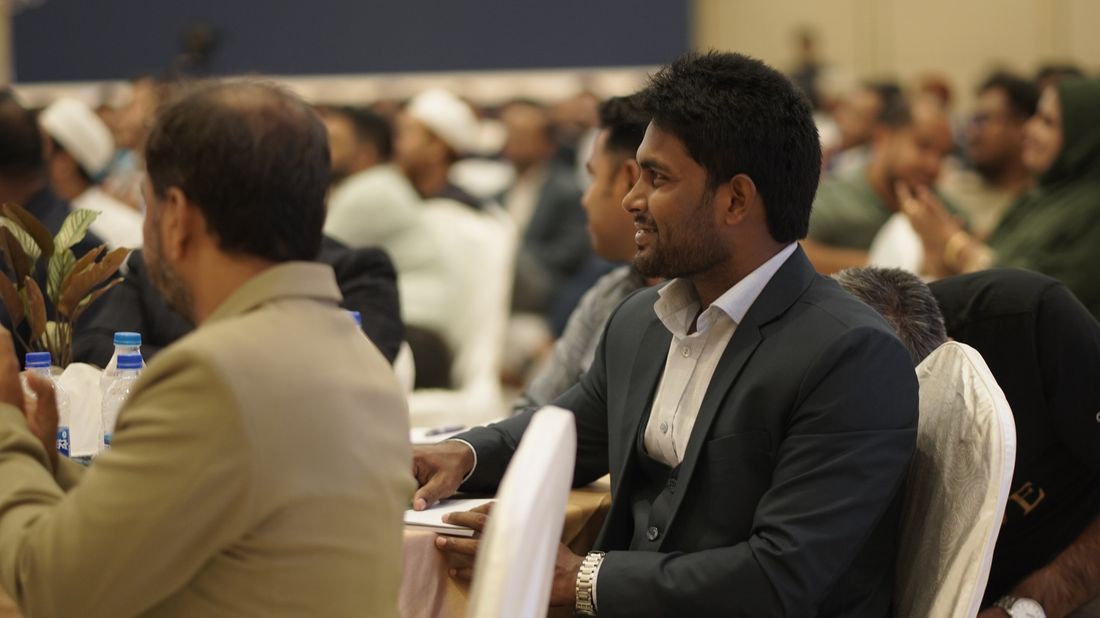 Md. Mahabub Mia seated among the audience at the event, smiling