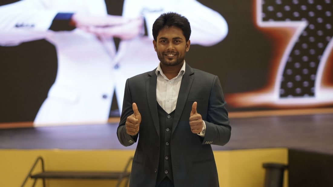 Md. Mahabub Mia on stage giving a thumbs-up